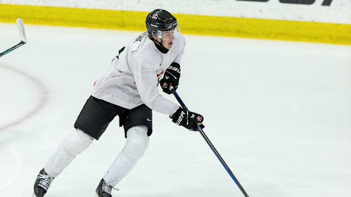 Aug 3, 2024; Plymouth, MI, USA; Canada's forward Calum Ritchie (11) turns up ice with the puck against USA during the first period of the 2024 World Junior Summer Showcase at USA Hockey Arena. Mandatory Credit: David Reginek-Imagn Images