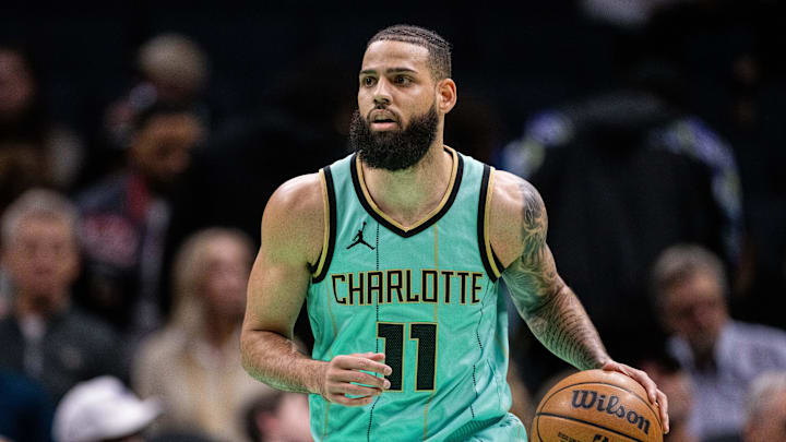 Jan 24, 2025; Charlotte, North Carolina, USA; Charlotte Hornets forward Cody Martin (11) brings the ball up court against the Portland Trail Blazers during the first quarter at Spectrum Center. Mandatory Credit: Scott Kinser-Imagn Images