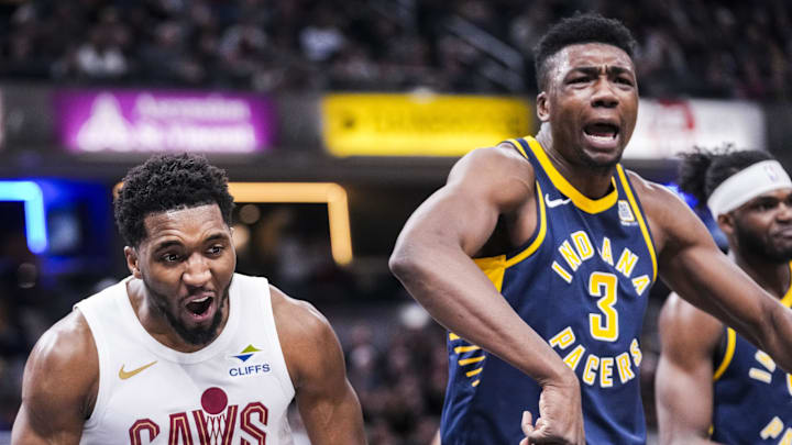 Jan 14, 2025; Indianapolis, IN, USA; Cleveland Cavaliers guard Donovan Mitchell (45) celebrates while Indiana Pacers center Thomas Bryant (3) expresses frustration Tuesday, Jan. 14, 2025, during an NBA game between the Indiana Pacers and the Cleveland Cavaliers at Gainbridge Fieldhouse in Indianapolis. The Cavaliers defeated the Pacers, 127-117. Mandatory Credit: Grace Smith/USA TODAY Network via Imagn Images 