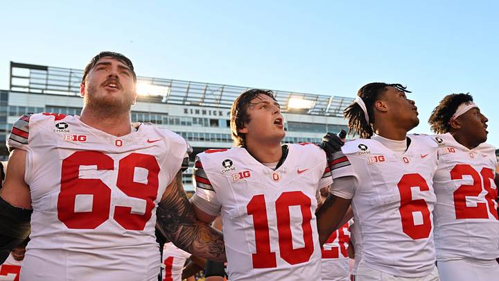 Oct 3, 2026; Iowa City, Iowa, USA; Ohio State Buckeyes offensive line Ian Moore (69) and quarterback Julian Sayin (10) and cornerback Devin Sanchez (6) celebrate after defeating the Iowa Hawkeyes at Kinnick Stadium. Mandatory Credit: Jeffrey Becker-Imagn Images Oct 3, 2026; Iowa City, Iowa, USA; Ohio State Buckeyes offensive line Ian Moore (69) and quarterback Julian Sayin (10) and cornerback Devin Sanchez (6) celebrate after defeating the Iowa Hawkeyes at Kinnick Stadium. Mandatory Credit: Jeffrey Becker-Imagn Images