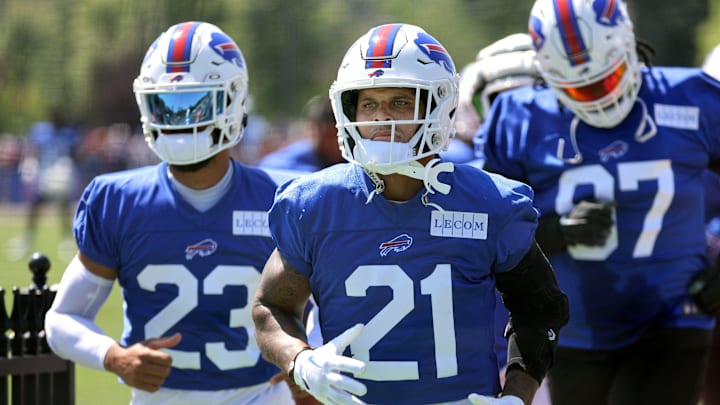 Bills safety Jordan Poyer (21) and Micah Hyde lead part of the defense to a back field for