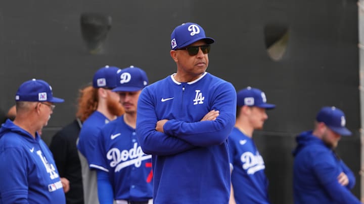 Feb 12, 2025; Glendale, AZ, USA; Los Angeles Dodgers manager Dave Roberts looks on during a Spring Training workout at Camelback Ranch. Mandatory Credit: Joe Camporeale-Imagn Images
