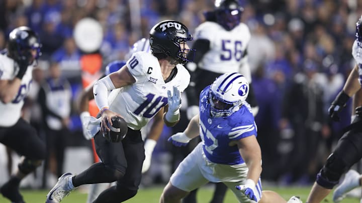 Nov 15, 2025; Provo, Utah, USA; Texas Christian University Horned Frogs quarterback Josh Hoover (10) is pressured by BYU Cougars defensive tackle Keanu Tanuvasa (57) during the second quarter at LaVell Edwards Stadium. Mandatory Credit: Rob Gray-Imagn Images