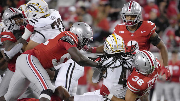 Sept. 7, 2024; Columbus, Ohio, USA; Western Michigan Broncos running back Keshawn King (4) is tackled by Ohio State Buckeyes defensive end Joshua Mickens (52) defensive lineman Jason Moore (94) and linebacker Gabe Powers (36) during the second half at Ohio Stadium. Mandatory Credit: Barbara J. Perenic/USA TODAY Network via Imagn Images