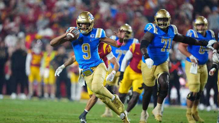Nov 29, 2025; Los Angeles, California, USA; UCLA Bruins quarterback Nico Iamaleava (9) carries the ball against the Southern California Trojans in the first half at United Airlines Field at Los Angeles Memorial Coliseum. Mandatory Credit: Kirby Lee-Imagn Images