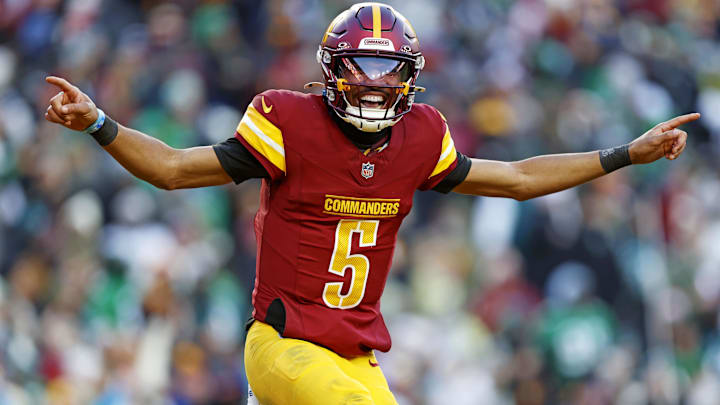 Dec 22, 2024; Landover, Maryland, USA; Washington Commanders quarterback Jayden Daniels (5) celebrates after throwing a touchdown during the fourth quarter against the Philadelphia Eagles at Northwest Stadium. Mandatory Credit: Peter Casey-Imagn Images