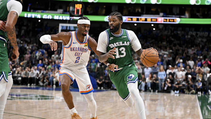 Oct 27, 2025; Dallas, Texas, USA; Dallas Mavericks forward Naji Marshall (13) brings the ball up court past Oklahoma City Thunder guard Shai Gilgeous-Alexander (2) during the second half at the American Airlines Center. Mandatory Credit: Jerome Miron-Imagn Images