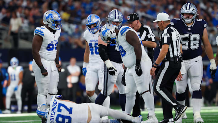 Oct 13, 2024; Arlington, Texas, USA;  Detroit Lions defensive end Aidan Hutchinson (97) injures himself while trying to tackle Dallas Cowboys quarterback Dak Prescott (not pictured) during the second half at AT&T Stadium. Mandatory Credit: Kevin Jairaj-Imagn Images