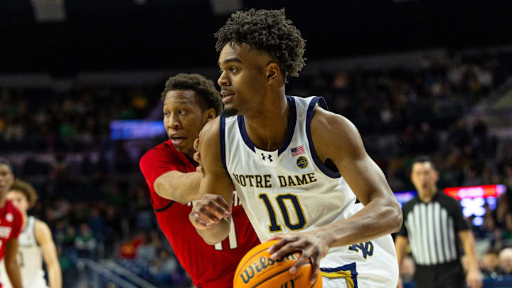 Feb 28, 2026; South Bend, Indiana, USA; Notre Dame Fighting Irish forward Jalen Haralson (10) drives as NC State Wolfpack guard Quadir Copeland (11) defends during the first half at Purcell Pavilion at the Joyce Center. Mandatory Credit: Michael Caterina-Imagn Images