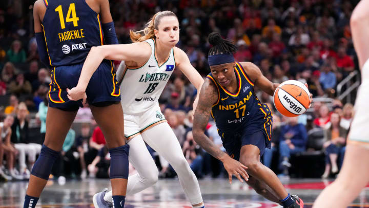 May 16, 2024; Indianapolis, IN, USA; Indiana Fever guard Erica Wheeler (17) drives the lane past New York Liberty guard Ivana Dojkic (18) on Thursday, May 16, 2024, during the Indiana Fever home opener game against the New York Liberty at Gainbridge Fieldhouse in Indianapolis. Mandatory Credit: Grace Hollars-USA TODAY Sports