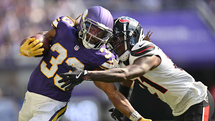 Sep 22, 2024; Minneapolis, Minnesota, USA; Minnesota Vikings running back Aaron Jones (33) runs the ball as Houston Texans safety Calen Bullock (21) makes the tackle during the fourth quarter at U.S. Bank Stadium. Mandatory Credit: Jeffrey Becker-Imagn Images