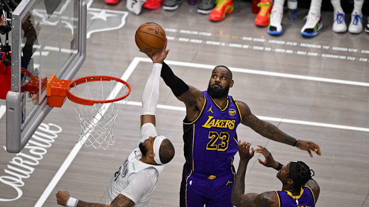 Apr 9, 2025; Dallas, Texas, USA; Dallas Mavericks center Daniel Gafford (21) and Los Angeles Lakers forward LeBron James (23) battle for the rebound during the first quarter at the American Airlines Center. Mandatory Credit: Jerome Miron-Imagn Images