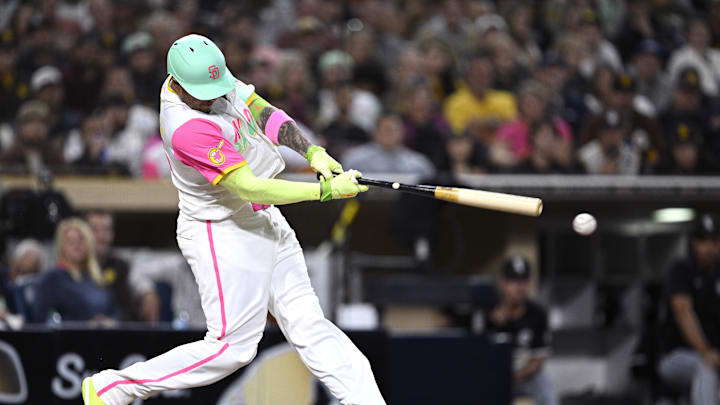 Sep 20, 2024; San Diego, California, USA; San Diego Padres third baseman Manny Machado (13) hits a single against the Chicago White Sox during the sixth inning at Petco Park. Mandatory Credit: Orlando Ramirez-Imagn Images