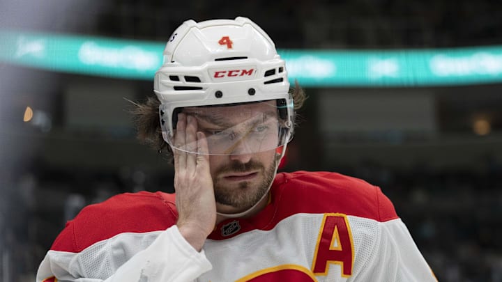 Apr 7, 2025; San Jose, California, USA; Calgary Flames defenseman Rasmus Andersson (4) wipes the inside of his visor during the second period against the San Jose Sharks at SAP Center at San Jose. Mandatory Credit: Stan Szeto-Imagn Images Apr 7, 2025; San Jose, California, USA; Calgary Flames defenseman Rasmus Andersson (4) wipes the inside of his visor during the second period against the San Jose Sharks at SAP Center at San Jose. Mandatory Credit: Stan Szeto-Imagn Images