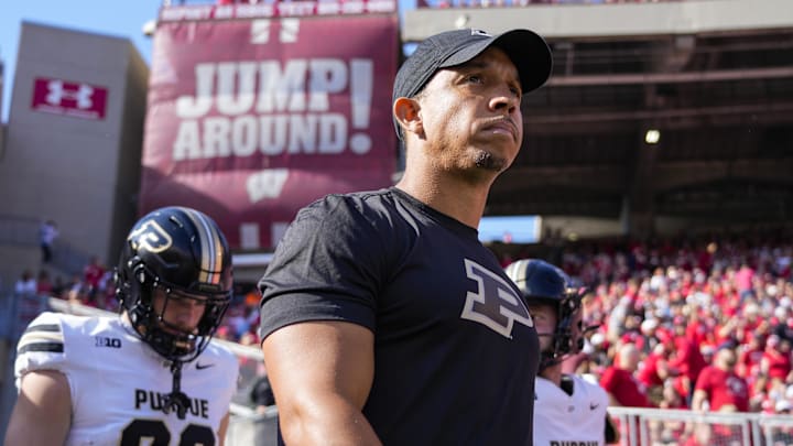 Ryan Walters leads Purdue onto the field against the Wisconsin Badgers.