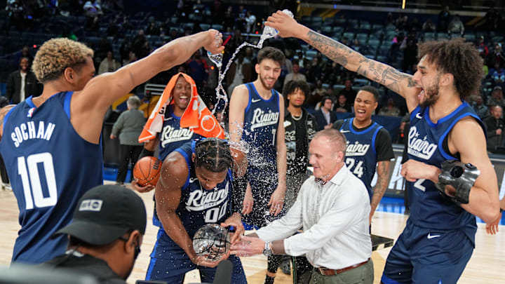 Feb 16, 2024; Indianapolis, Indiana, USA; Team Jalen forward Jeremy Sochan (10) of the San Antonio Spurs and center Dereck Lively II (2) of the Dallas Mavericks pour water onto guard Bennedict Mathurin (0) of the Indiana Pacers after winning the Rising Stars final at Gainbridge Fieldhouse. Mandatory Credit: Kyle Terada-Imagn Images