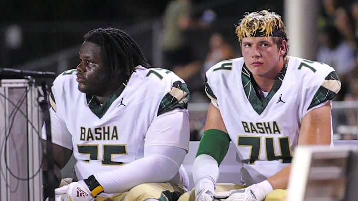Basha tackles Dajohn Yarborough (75) and Jake Hildebrand (74) sit on the bench after another rushing touchdown against Brophy Prep during a game at Central High School in Phoenix on Aug. 28, 2025.