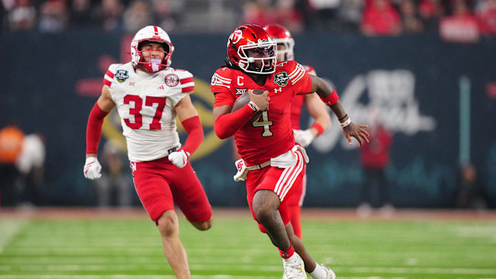 Utah Utes quarterback Devon Dampier (4) carries the ball against Nebraska Cornhuskers defensive back Donovan Jones (37) in the second half during the SRS Distribution Las Vegas Bowl at Allegiant Stadium. 