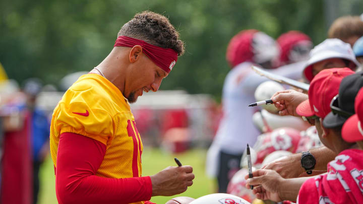 Jul 22, 2025; St. Joseph, MO, USA; Kansas City Chiefs quarterback Patrick Mahomes (15) signs autographs for fans after training camp at Missouri Western State University. Mandatory Credit: Denny Medley-Imagn Images