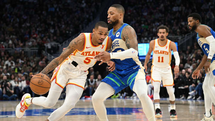 Dec 2, 2023; Milwaukee, Wisconsin, USA; Atlanta Hawks guard Dejounte Murray (5) drives to the basket against Milwaukee Bucks guard Damian Lillard (0) in the second half at Fiserv Forum. Mandatory Credit: Michael McLoone-USA TODAY Sports