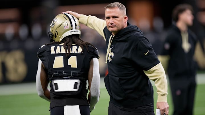 Dec 1, 2024; New Orleans, Louisiana, USA; New Orleans Saints interim head coach Darren Rizzi greets New Orleans Saints running back Alvin Kamara (41) before a game against the Los Angeles Rams at Caesars Superdome. 