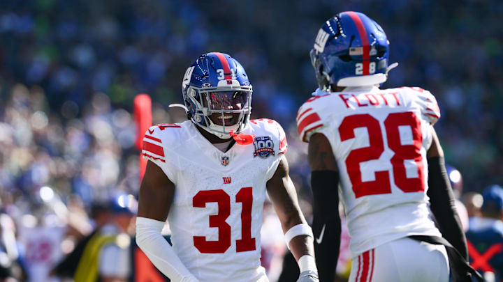 Oct 6, 2024; Seattle, Washington, USA; New York Giants safety Tyler Nubin (31) and cornerback Cor'Dale Flott (28) celebrate after Nubin recovered a Seattle Seahawks fumble during the second half at Lumen Field.  