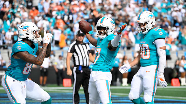 Oct 5, 2025; Charlotte, North Carolina, USA; Miami Dolphins wide receiver Jaylen Waddle (17) pretends to pose for a picture after scoring a touchdown for tight end Darren Waller (83) as fullback Alec Ingold (30) celebrates in the fourth quarter at Bank of America Stadium. Mandatory Credit: Bob Donnan-Imagn Images Oct 5, 2025; Charlotte, North Carolina, USA; Miami Dolphins wide receiver Jaylen Waddle (17) pretends to pose for a picture after scoring a touchdown for tight end Darren Waller (83) as fullback Alec Ingold (30) celebrates in the fourth quarter at Bank of America Stadium. Mandatory Credit: Bob Donnan-Imagn Images