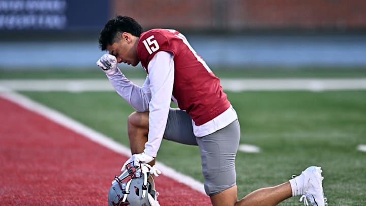 Aug 30, 2025; Pullman, Washington, USA; Washington State Cougars wide receiver Jeremiah Noga (15) prays before a game against the Idaho Vandals at Gesa Field at Martin Stadium. Mandatory Credit: James Snook-Imagn Images