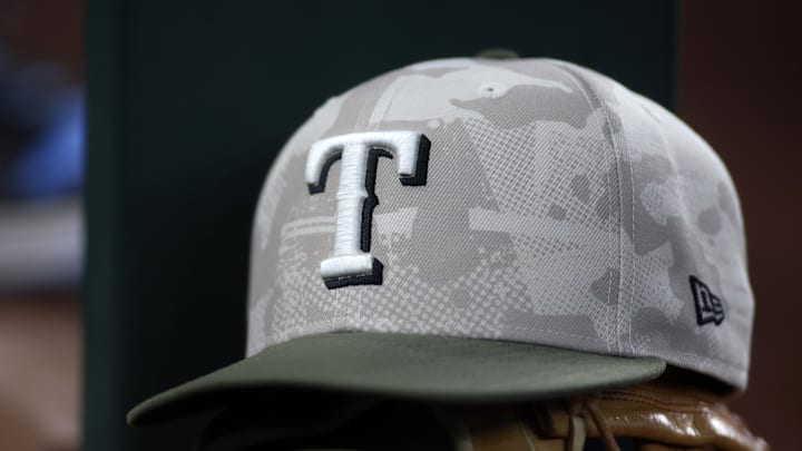 May 18, 2025; Arlington, Texas, USA;  Texas Rangers hat in honor of the military in the dugout  during the second inning against the Houston Astros at Globe Life Field. Mandatory Credit: Tim Heitman-Imagn Images