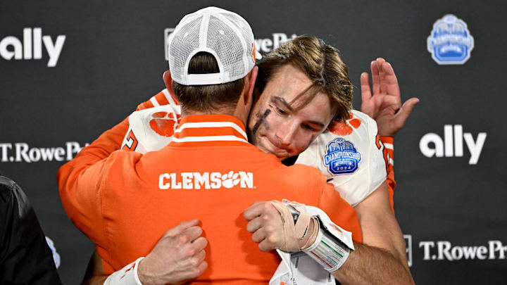 Dec 7, 2024; Charlotte, NC, USA; Clemson Tigers head coach Dabo Swinney, and quarterback Cade Klubnik (2) celebrate after winning the 2024 ACC Championship game against the Southern Methodist Mustangs at Bank of America Stadium. Mandatory Credit: Bob Donnan-Imagn Images