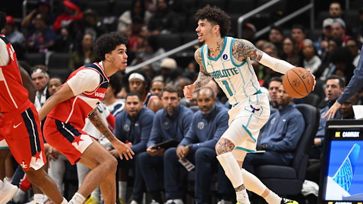 Oct 26, 2025; Washington, District of Columbia, USA; Charlotte Hornets guard LaMelo Ball (1) prepares to drive past Washington Wizards guard Will Riley (27) during the second quarter at Capital One Arena. Mandatory Credit: Rafael Suanes-Imagn Images