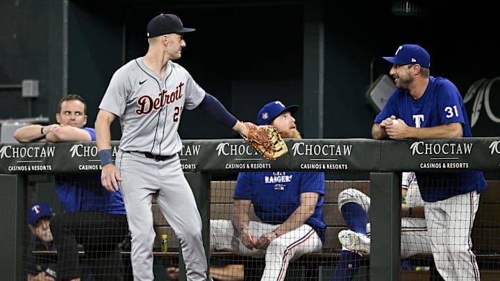 Jun 3, 2024; Arlington, Texas, USA; Detroit Tigers first baseman Mark Canha (21) talks with Texas Rangers starting pitcher Max Scherzer (31) during the fifth inning at Globe Life Field. Mandatory Credit: Jerome Miron-Imagn Images