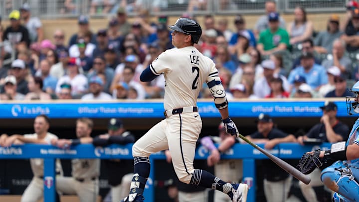 Jun 8, 2025; Minneapolis, Minnesota, USA; Minnesota Twins third baseman Brooks Lee (2) hits a single during the second inning against the Toronto Blue Jays at Target Field. Mandatory Credit: Jordan Johnson-Imagn Images