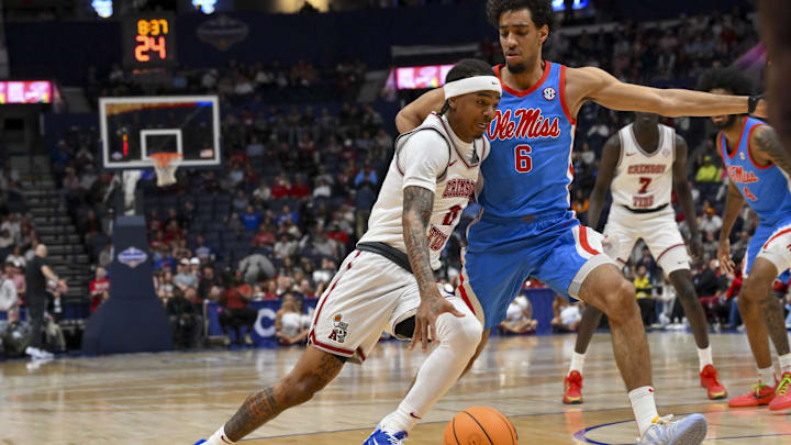 Mar 13, 2026; Nashville, TN, USA;  Alabama Crimson Tide guard Labaron Philon (0) dribbles the ball past Mississippi Rebels guard Ilias Kamardine (6) during the first half at Bridgestone Arena.