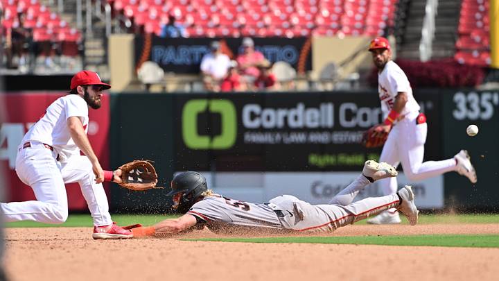 Sep 16, 2026; St. Louis, Missouri, USA;  San Francisco Giants center fielder Jonah Cox (53) dives to second base as St. Louis Cardinals shortstop Thomas Saggese (25) waits on the throw at Busch Stadium in the ninth inning. The call was overturned after review and he was out.  Mandatory Credit: Tim Vizer-Imagn Images