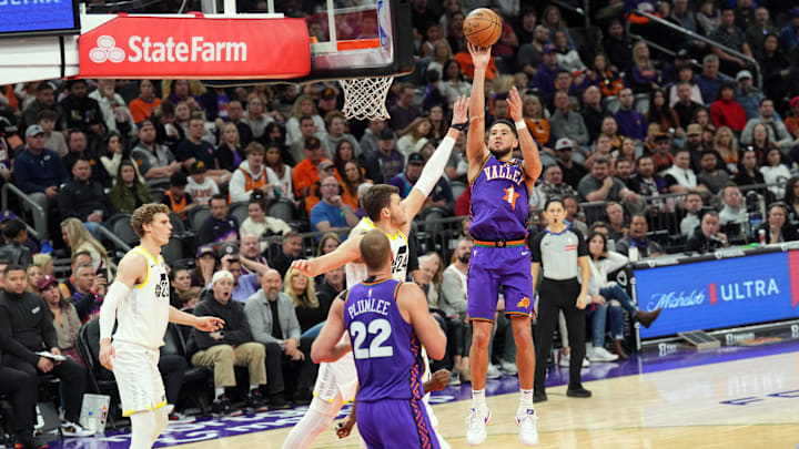 Jan 11, 2025; Phoenix, Arizona, USA; Phoenix Suns guard Devin Booker (1) shoots against the Utah Jazz during the second half at Footprint Center. Mandatory Credit: Joe Camporeale-Imagn Images