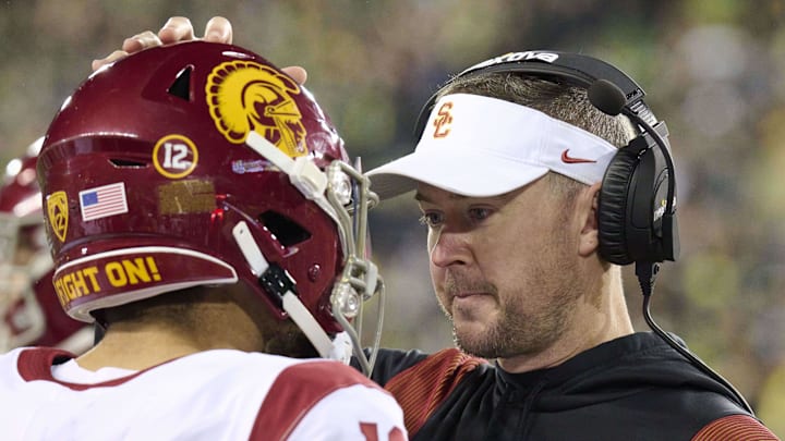 Nov 11, 2023; Eugene, Oregon, USA; USC Trojans head coach Lincoln Riley talks to quarterback Caleb Williams (13) during the first half against the Oregon Ducks at Autzen Stadium. Mandatory Credit: Troy Wayrynen-USA TODAY Sports