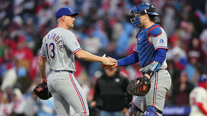 Texas Rangers relief pitcher Tyler Alexander shakes hands with catcher Danny Jansen.