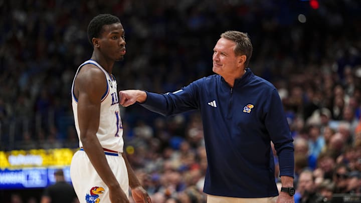 Jan 13, 2026; Lawrence, Kansas, USA; Kansas Jayhawks head coach Bill Self talks with guard Melvin Council Jr. (14) during the second half against the Iowa State Cyclones at Allen Fieldhouse. Mandatory Credit: Jay Biggerstaff-Imagn Images