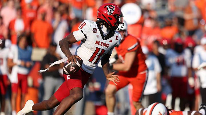 Aug 29, 2026; Charlottesville, Virginia, USA;  North Carolina State Wolfpack quarterback CJ Bailey (11) scrambles during the game against the Virginia Cavaliers at Scott Stadium.  Mandatory Credit: Greg Atkins-Imagn Images