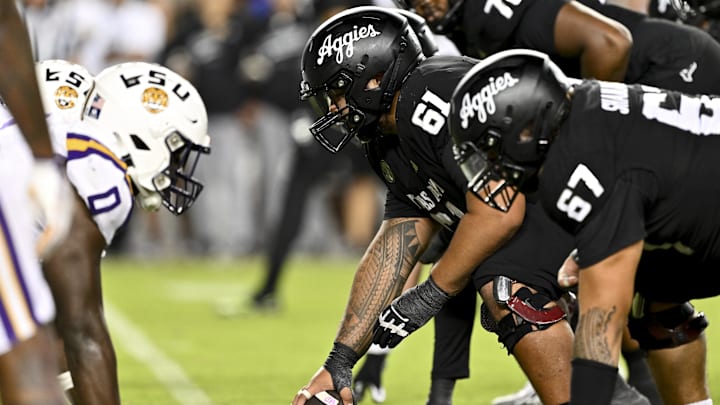 Oct 26, 2024; College Station, Texas, USA; Texas A&M Aggies offensive lineman Kolinu'u Faaiu (61) sets the ball in the fourth quarter against the LSU Tigers at Kyle Field. Mandatory Credit: Maria Lysaker-Imagn Images. 