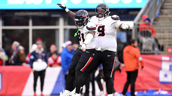Oct 13, 2024; Foxborough, Massachusetts, USA; Houston Texans running back Dameon Pierce (31) celebrates with guard Shaq Mason (69) after scoring a touchdown against the New England Patriots during the second half at Gillette Stadium. Mandatory Credit: Brian Fluharty-Imagn Images
