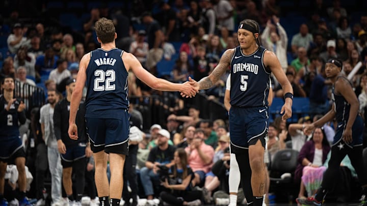 Mar 17, 2024; Orlando, Florida, USA; Orlando Magic forward Paolo Banchero (5) celebrates with Orlando Magic forward Franz Wagner (22) in the fourth quarter against the Toronto Raptors at KIA Center. Mandatory Credit: Jeremy Reper-Imagn Images