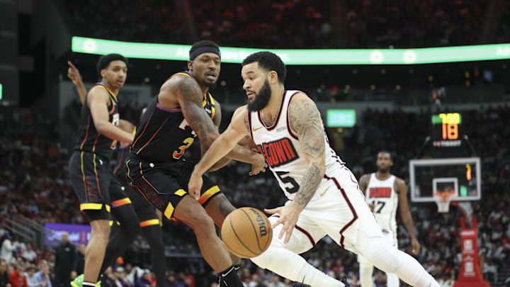 Mar 12, 2025; Houston, Texas, USA; Houston Rockets guard Fred VanVleet (5) drives with the ball as Phoenix Suns guard Bradley Beal (3) defends during the fourth quarter at Toyota Center.
