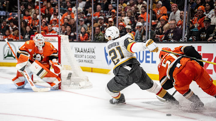 May 10, 2026; Anaheim, California, USA; Vegas Golden Knights center Brett Howden (21) skates with the puck against Anaheim Ducks defenseman Olen Zellweger (51) during the third period in game four of the second round of the 2026 Stanley Cup Playoffs at Honda Center. Mandatory Credit: Corinne Votaw-Imagn Images
