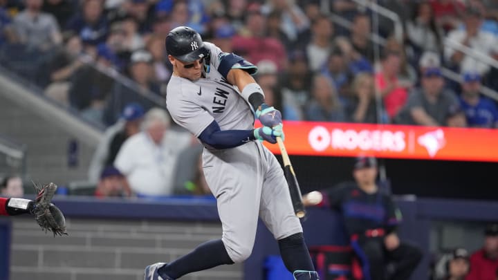 Jun 28, 2024; Toronto, Ontario, CAN; New York Yankees center fielder Aaron Judge (99) hits a single against the Toronto Blue Jays during the sixth inning at Rogers Centre. Mandatory Credit: Nick Turchiaro-USA TODAY Sports