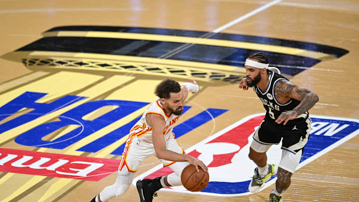 Dec 14, 2024; Las Vegas, Nevada, USA; Atlanta Hawks guard Trae Young (11) controls the ball against Milwaukee Bucks guard Gary Trent Jr. (5) during the fourth quarter in a semifinal of the 2024 Emirates NBA Cup at T-Mobile Arena. Mandatory Credit: Candice Ward-Imagn Images