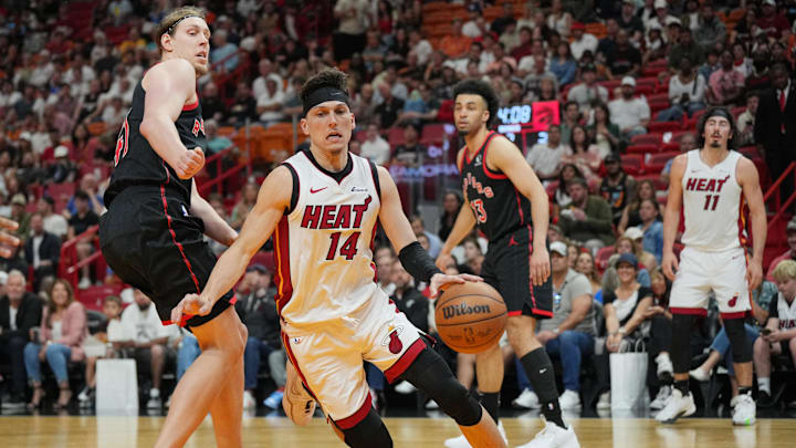 Apr 14, 2024; Miami, Florida, USA;  Miami Heat guard Tyler Herro (14) drives past Toronto Raptors forward Kelly Olynyk (41) during the first half at Kaseya Center. Mandatory Credit: Jim Rassol-Imagn Images