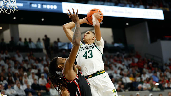 Jan 10, 2026; Waco, Texas, USA;  Baylor Bears guard Cameron Carr (43) shoots as Houston Cougars forward Joseph Tugler (11) defends during the second half at Paul and Alejandra Foster Pavilion. Mandatory Credit: Chris Jones-Imagn Images