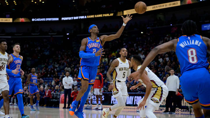 Dec 7, 2024; New Orleans, Louisiana, USA; Oklahoma City Thunder guard Shai Gilgeous-Alexander (2) passes to Oklahoma City Thunder forward Jalen Williams (8) who finished it off with a dunk against the New Orleans Pelicans during the first half at Smoothie King Center. Mandatory Credit: Matthew Hinton-Imagn Images